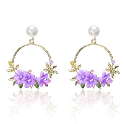 Eleganta örhängen i guld med blommor och pärlor