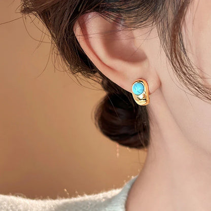 Tidlösa Böjda Örhängen i Koppar med Turkos