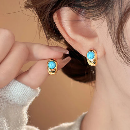 Tidlösa Böjda Örhängen i Koppar med Turkos